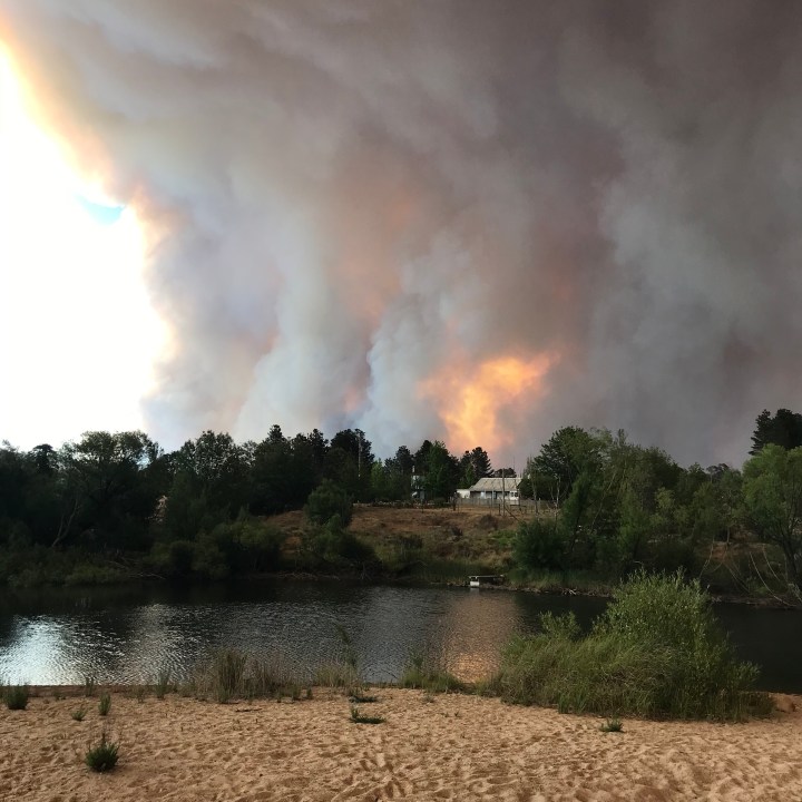 House by a river with huge flames behind it Riverbend Ray Monde