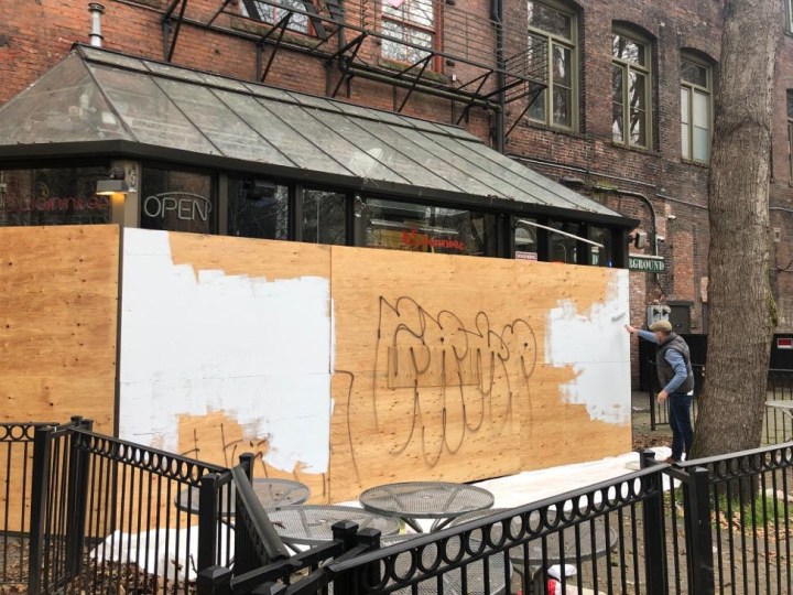 Artist Ray Monde painting hoarding in Occidental Square Seattle