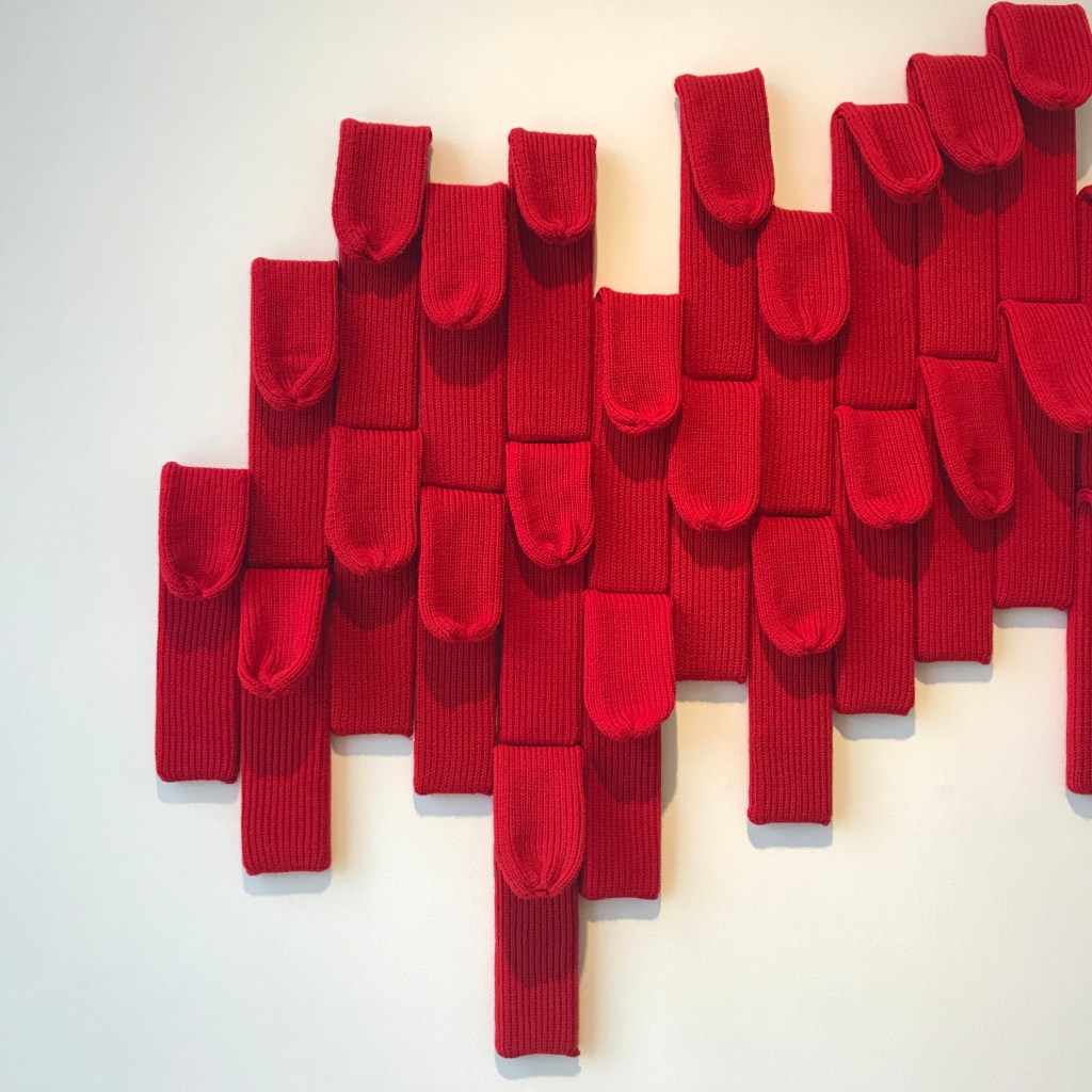 A series of red socks made to look like tongues