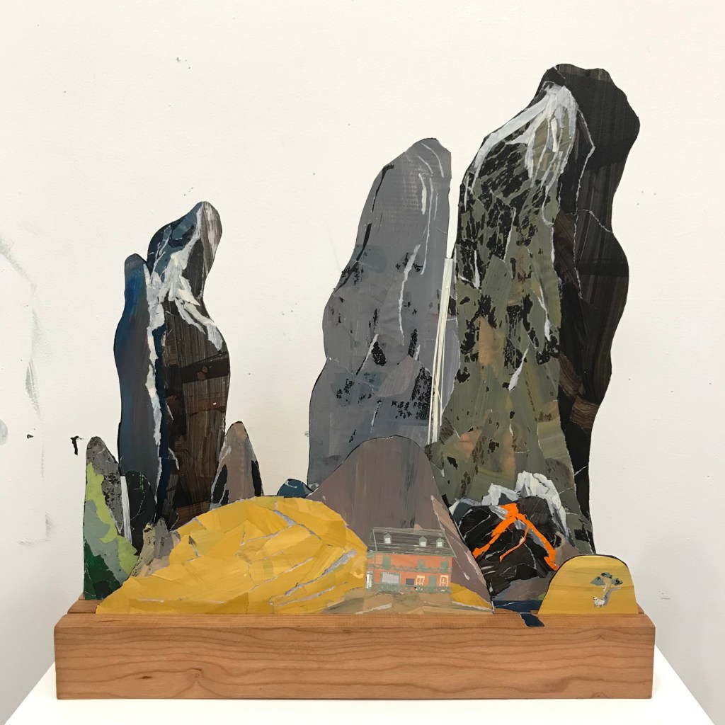 An Australian pub in front of looming mountains as a sculpture by Ray Monde