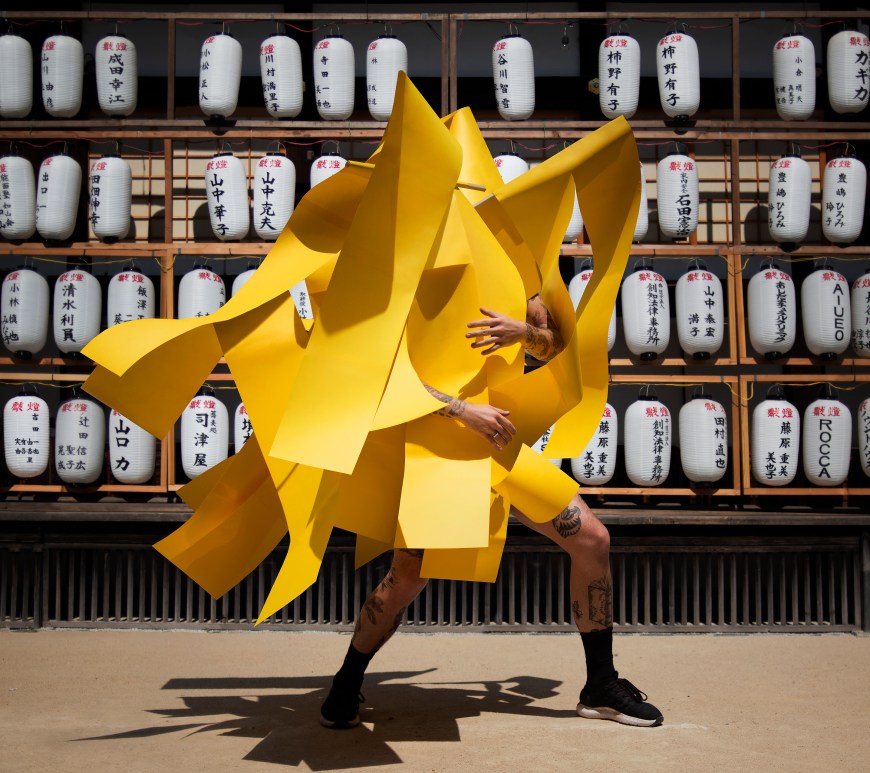 Image of artist Gerwyn Davies in yellow with japanese lantern