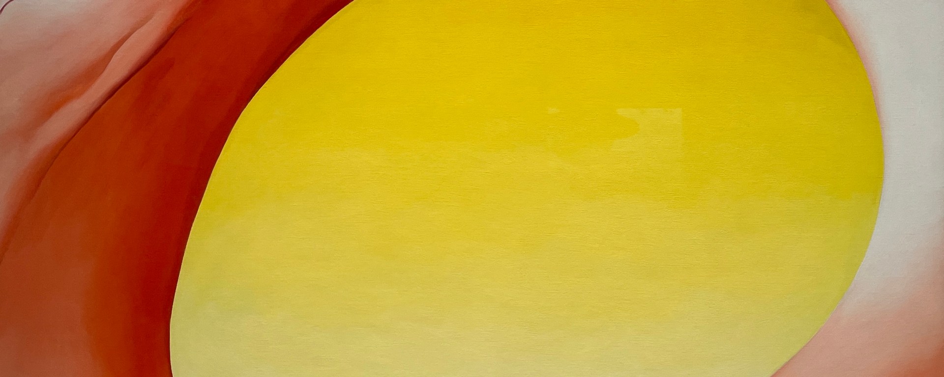 An artwork by Georgia O'Keeffe of a egg yellow hole in a large red pelvis